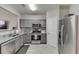 Modern kitchen features stainless steel appliances and gray cabinets at 3826 Dandridge Way, Duluth, GA 30096