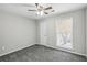 Carpeted bedroom featuring a ceiling fan, a window, and neutral-toned walls at 4322 Idlewood Ln, Tucker, GA 30084