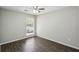 Well-lit bedroom showcasing the dark vinyl wood flooring and a ceiling fan at 4322 Idlewood Ln, Tucker, GA 30084