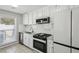Well-lit kitchen featuring white cabinets, stainless steel appliances, and subway tile backsplash at 4322 Idlewood Ln, Tucker, GA 30084