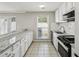 Bright kitchen showcasing an extensive countertop space, white cabinets, and modern appliances at 4322 Idlewood Ln, Tucker, GA 30084