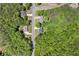 An aerial view shows the house nestled among lush green trees, offering privacy and natural beauty at 100 Oakwind Pkwy, Canton, GA 30114