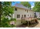 Back exterior of home with neutral siding featuring a deck with stairs and yard at 100 Oakwind Pkwy, Canton, GA 30114