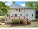 Back of home with deck. The elevated deck is perfect for outdoor entertaining and enjoying the scenery at 100 Oakwind Pkwy, Canton, GA 30114