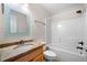 Bathroom featuring a granite countertop, a white tiled shower over tub, and modern fixtures at 100 Oakwind Pkwy, Canton, GA 30114