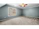 Spacious bedroom features a ceiling fan and a window with sunlight at 100 Oakwind Pkwy, Canton, GA 30114