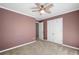 Bedroom with neutral carpet, ceiling fan, and white closet doors at 100 Oakwind Pkwy, Canton, GA 30114