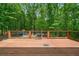 Wooden deck area in a wooded backyard with railings at 100 Oakwind Pkwy, Canton, GA 30114