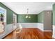 Spacious dining room featuring hardwood floors, and classic wainscoting detail at 100 Oakwind Pkwy, Canton, GA 30114
