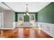 Traditional dining room with a chandelier, green walls, and ample natural light at 100 Oakwind Pkwy, Canton, GA 30114
