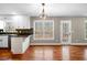 Eat-in kitchen boasting white cabinets, a breakfast bar, and outdoor access at 100 Oakwind Pkwy, Canton, GA 30114
