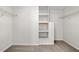 Walk-in closet with built-in shelving and carpeted floors, offering ample storage space at 100 Oakwind Pkwy, Canton, GA 30114