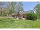 Expansive backyard featuring a patio area, lush lawn, and mature trees, offering a private outdoor retreat at 3969 Potomac Nw Dr, Kennesaw, GA 30144