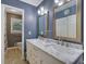 Well-lit bathroom with double vanity, marble countertops, and neutral paint at 3969 Potomac Nw Dr, Kennesaw, GA 30144