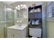 Traditional bathroom featuring a single sink vanity, shower, and cabinet for storage at 3969 Potomac Nw Dr, Kennesaw, GA 30144