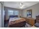 Comfortable bedroom with ceiling fan, dresser, and warm lighting at 3969 Potomac Nw Dr, Kennesaw, GA 30144