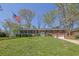 Charming brick home with an American flag, lush green lawn, mature trees and a welcoming front entrance at 3969 Potomac Nw Dr, Kennesaw, GA 30144