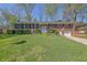Traditional brick home featuring a well-maintained lawn, mature trees, and an inviting entryway with white door at 3969 Potomac Nw Dr, Kennesaw, GA 30144