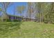 Beautiful brick home with a manicured lawn, mature trees, and American flag displayed at 3969 Potomac Nw Dr, Kennesaw, GA 30144