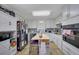 White and bright kitchen with an island, ample counter space, modern appliances and beautiful cabinetry at 3969 Potomac Nw Dr, Kennesaw, GA 30144