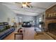 Open living room with fireplace, hardwood floors, ceiling fan, and backyard access at 3969 Potomac Nw Dr, Kennesaw, GA 30144