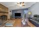 Inviting living room with brick fireplace, ceiling fan, and hardwood floors at 3969 Potomac Nw Dr, Kennesaw, GA 30144