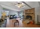Bright living room with fireplace, hardwood floors, ceiling fan, and backyard access at 3969 Potomac Nw Dr, Kennesaw, GA 30144