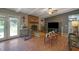 Comfortable living room with brick fireplace, ceiling fan, and access to the backyard at 3969 Potomac Nw Dr, Kennesaw, GA 30144