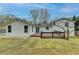 Lovely backyard view featuring a wood deck and a freshly sodded lawn at 5155 Rosestone Nw Dr, Lilburn, GA 30047