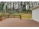 Spacious backyard deck overlooking a leafy backyard at 5155 Rosestone Nw Dr, Lilburn, GA 30047