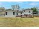 White home boasts a well-maintained backyard, deck, and inviting sliding glass door at 5155 Rosestone Nw Dr, Lilburn, GA 30047