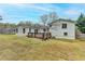 Expansive backyard showcases a deck, sodded lawn, and a bright, white exterior at 5155 Rosestone Nw Dr, Lilburn, GA 30047