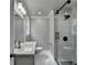 Bathroom featuring a glass enclosed shower with black fixtures and white marble tiles, and a modern sink at 5155 Rosestone Nw Dr, Lilburn, GA 30047