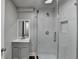 Modern bathroom featuring a glass shower enclosure, marble tile, and stylish gray vanity at 5155 Rosestone Nw Dr, Lilburn, GA 30047
