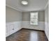 A well lit bedroom with trim work, and a large window at 5155 Rosestone Nw Dr, Lilburn, GA 30047