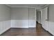 Bedroom with hardwood floors, trim work, and an open door at 5155 Rosestone Nw Dr, Lilburn, GA 30047