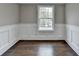 Bright room with beautiful trim work and hardwood floors with a large window at 5155 Rosestone Nw Dr, Lilburn, GA 30047