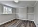 Bedroom with wood floors and large window is bright and comfortable at 5155 Rosestone Nw Dr, Lilburn, GA 30047
