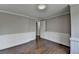 Bedroom with hardwood floors, trim work, and an open door at 5155 Rosestone Nw Dr, Lilburn, GA 30047