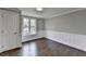 Bedroom features dark hardwood floors and baseboard trim at 5155 Rosestone Nw Dr, Lilburn, GA 30047