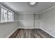 Bedroom with wood floors and large window offers plenty of light at 5155 Rosestone Nw Dr, Lilburn, GA 30047