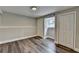 Bedroom with hardwood floors, fresh paint, two closets and a window at 5155 Rosestone Nw Dr, Lilburn, GA 30047