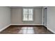 Sunny bedroom with hardwood floors, natural light, and neutral paint ready for furnishings at 5155 Rosestone Nw Dr, Lilburn, GA 30047