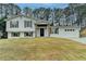 Charming two-story home featuring a well-manicured lawn and a two-car garage at 5155 Rosestone Nw Dr, Lilburn, GA 30047
