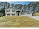 Charming two-story home featuring a well-manicured lawn and a two-car garage at 5155 Rosestone Nw Dr, Lilburn, GA 30047