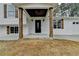 Inviting front porch with wood columns and a modern front door at 5155 Rosestone Nw Dr, Lilburn, GA 30047