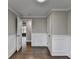 Hallway with grey walls, trim work, and a door on each side at 5155 Rosestone Nw Dr, Lilburn, GA 30047
