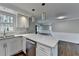 Bright, eat-in kitchen with stainless steel dishwasher, white cabinets, and lots of counter space at 5155 Rosestone Nw Dr, Lilburn, GA 30047