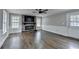 Cozy living room with stone fireplace, ceiling fan, and hardwood floors at 5155 Rosestone Nw Dr, Lilburn, GA 30047