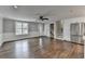 Open-concept living area featuring hardwood floors, stainless steel appliances, and a staircase at 5155 Rosestone Nw Dr, Lilburn, GA 30047